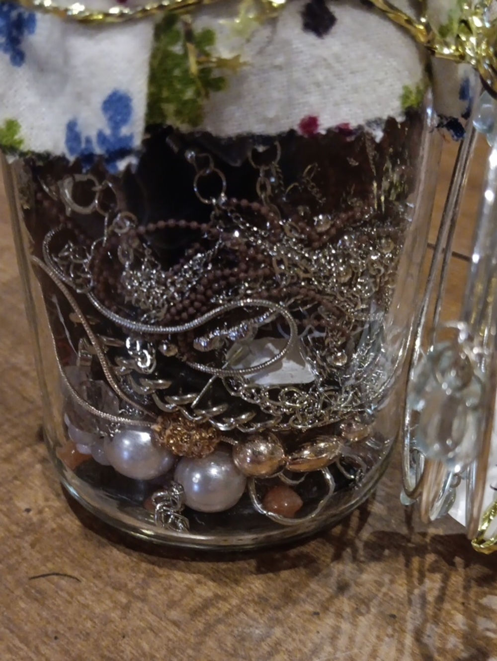 Jewerly Jar Featuring A Silver-Tone Mixed Bead and Chain Bracelet